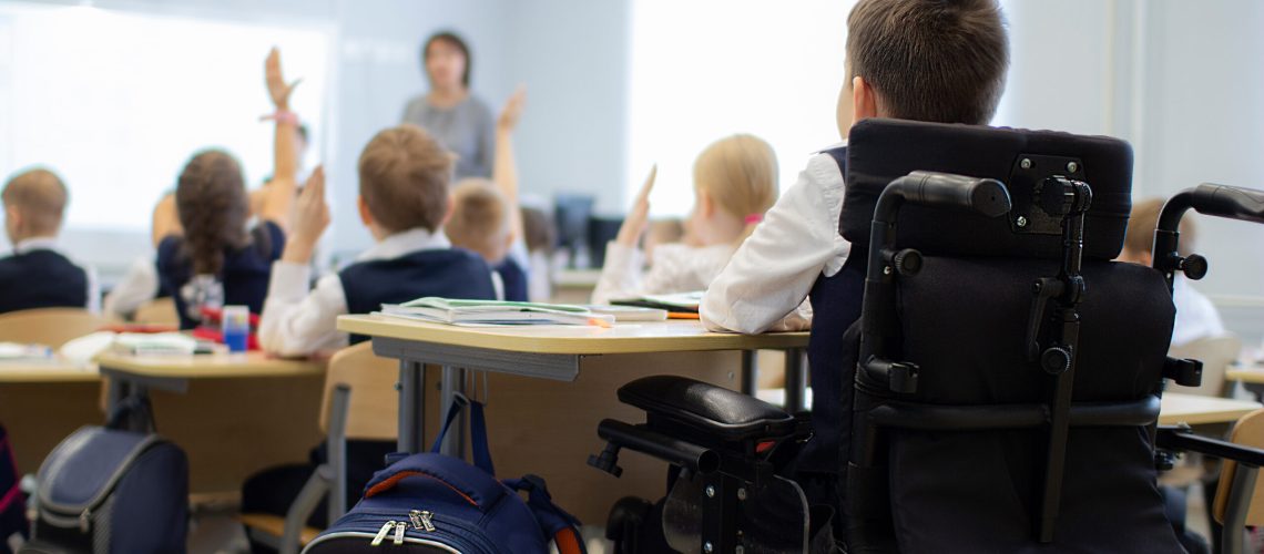 A disabled student in a wheelchair in primary school. Socialization of the individual in society.